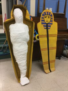 two cardboard sculptures are sitting on the floor