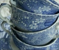 four blue and white dishes stacked on top of each other with floral designs in them