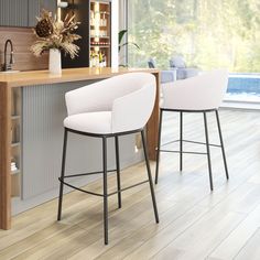 two white bar stools sitting in front of a counter top next to a window