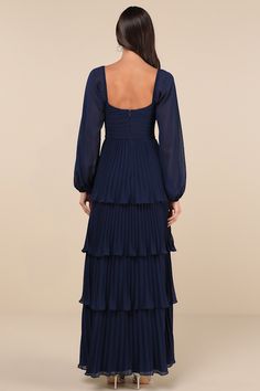 Let everyone be impressed by your stunning style in the Lulus Impactful Elegance Navy Blue Tiered Balloon Sleeve Maxi Dress! Airy, lightweight woven fabric shapes this gorgeous dress that has long balloon sleeves with elastic at the cuffs and shoulders. Sweetheart neckline tops a pleated bodice with a ruched detail at the front and a fitted waist. Accordion-pleated skirt falls in graceful tiers to a maxi hem. Hidden zipper/clasp at back. Fit: This garment fits true to size. Length: Floor length. Long Sleeve Ruched Maxi Dress For Dinner, Elegant Balloon Sleeve Pleated Dresses, Formal Ruffled Lantern Sleeve Dresses, Fitted Tiered Dress With Gathered Sleeves, Formal Lantern Sleeve Ruffled Dress, Elegant Dress With Pleated Balloon Sleeves, Fitted Chiffon Dresses With Pleated Sleeves, Elegant Pleated Dress With Balloon Sleeves, Billowy Lantern Sleeve Party Dress