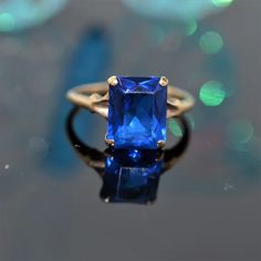 A ladies 10 karat yellow gold "Helm & Hahn" ring set with an 8 by 10 millimeter rectangular synthetic blue spinel.  The ring is size 6 Judith Leiber Couture, Blue Spinel, Rose Gold Morganite, Spinel Ring, Diamond Anniversary Rings, Diamond Anniversary, Radiant Cut, Fantasy Jewelry, Mens Accessories Fashion