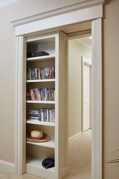 an open bookcase in the corner of a room with carpeted floor and walls