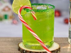 a green drink with a candy cane in it