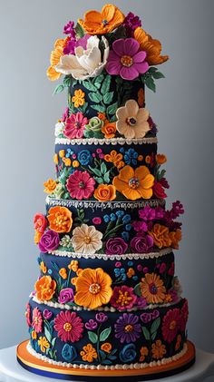 a multi - tiered cake decorated with colorful flowers