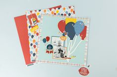 two scrapbook pages with balloons on them, one is blue and the other is red