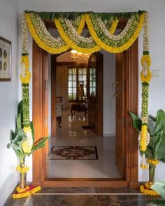 an entrance decorated with flowers and greenery