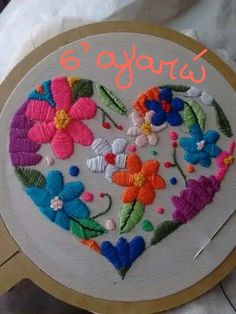 an embroidered heart with flowers on it