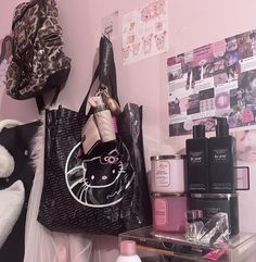 a hello kitty handbag is hanging on a wall next to other cosmetics and perfume bottles