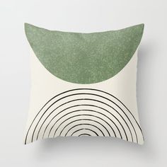 a green and white throw pillow with an abstract design on the front, along with black lines