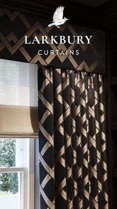 the logo for larkburn curtains hangs above a window with black and gold patterned drapes