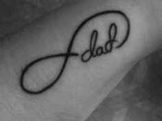 a small wrist tattoo with the word dad on it