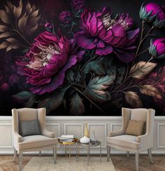 two chairs and a table in front of a floral wall mural