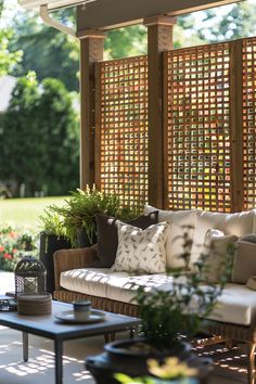 an outdoor living area with couches and tables