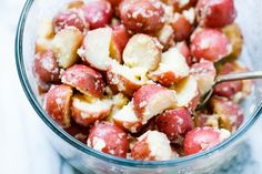 a glass bowl filled with red and white food