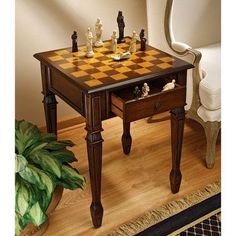 a chess set on a table in front of a chair