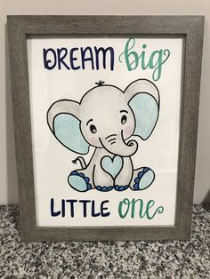 a framed sign with an elephant and the words dream big, little one on it