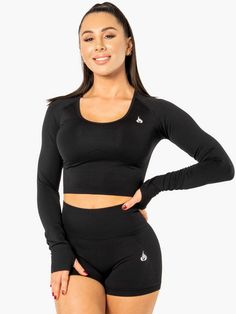 Seamless Snug Fit Activewear, Functional Black Top With Seamless Design, Functional Black Tops With Seamless Design, Functional Black Seamless Tops, Black Elastane Tops For Training, Snug Fit Winter Activewear For Gym, Winter Activewear With Snug Fit For Gym, Black Yoga Activewear With Thumbholes, Black Seamless Elastane Activewear