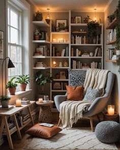 a living room filled with lots of furniture and bookshelves next to a window