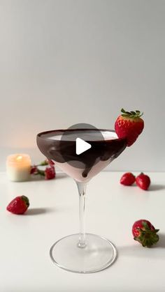 the chocolate martini is garnished with strawberries, and has a candle in it