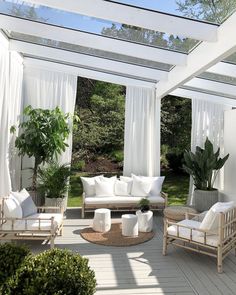 an instagram page with white furniture and curtains on the outside patio, in front of a pergolated gazebo