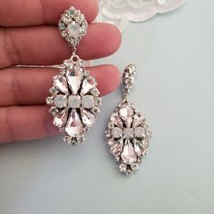 Hollywood Glam crystal earrings, made with top Swarovski rhinestones hand sett on silver filigree drop . finished with hypo allergenic surgical steal ear wire. Original design , hand crafted by me in my studio. Light weigh and very comfortable to wear . Other related accessories are coming soon ( necklace) Suggested Bracelet: https://www.etsy.com/listing/721178495/white-opal-wedding-cuff-bracelet-crystal?ref=shop_home_active_7 Please contact me if you have any questions. Dazzling Silver Crystal Cluster Earrings, Dangle Rhinestone Bridal Earrings As Gift, Crystal Embellished Drop Bridal Earrings As Gift, Crystal Embellished Drop Earrings For Bridal Gift, Dangle Bridal Earrings With Rhinestones, Bridal Dangle Earrings With Rhinestones, Dazzling White Crystal Earrings, Wedding Crystal Cluster Earrings With Sparkling Stones, White Crystal Chandelier Earrings For Formal Occasions