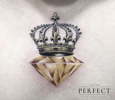 a tattoo with a crown on top of it's chest and diamond in the middle