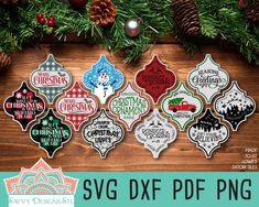 the svg dxf christmas ornaments are on display in front of pine cones