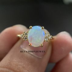 𝐌𝐚𝐢𝐧 𝐒𝐭𝐨𝐧𝐞 𝐃𝐞𝐭𝐚𝐢𝐥𝐬 *Type: Opal *Cut: Oval *Colour: FG *Clarity: VVS1 *Weight: 1.80 Ct (approx) 𝐒𝐢𝐝𝐞 𝐒𝐭𝐨𝐧𝐞 𝐃𝐞𝐭𝐚𝐢𝐥𝐬 *Type: Cubic Zirconia *Shape: Round *Colour: FG *Clarity: VVS1 *Weight: 0.20 Ct (approx) 𝐑𝐢𝐧𝐠 𝐃𝐞𝐭𝐚𝐢𝐥𝐬 *Metal Purity: Solid Gold (10k / 14k / 18k), 925 Sterling Silver *Metal Tone: White / Rose / Yellow *Stamp / Hallmarked: Yes Customization *Diamond: Natural Diamond / Moissanite / CVD -Lab Grown / Cubic Zirconia 𝐑𝐮𝐬𝐡 𝐎𝐫𝐝𝐞𝐫 *Our stan Pearl And Opal Engagement Ring, Anniversary Opal Ring Stamped 14k In Oval Shape, 14k White Gold Opal Ring With Round Cut, Oval Opal Cluster Ring For Wedding, 14k Gold Moonstone Ring With Accent Stones For Anniversary, Diamond White 14k Gold Ring With Accent Stones, Oval Opal Ring Stamped 14k For Anniversary, Gold Opal Birthstone Ring For Anniversary, White Gold Opal Ring In 14k Round Cut