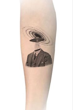 a man's leg with an image of a black and white object on it