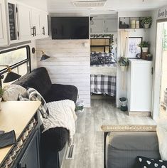 the interior of a camper with black and white decor