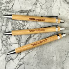 four pens sitting on top of a marble counter next to each other with the words ponder school