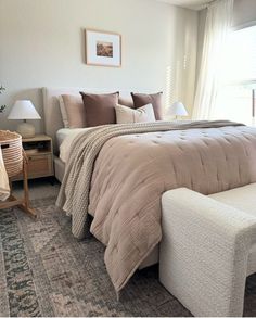 a bedroom with a bed, chair and window