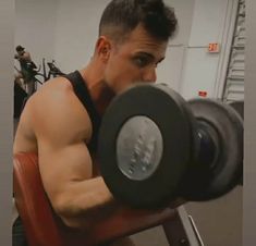 a man lifting a dumbbell in a gym