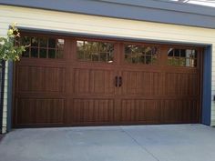 a brown garage door with windows on the side