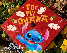 a red graduation cap with stitching on it that says, for my ohana