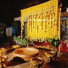 a decorated stage with yellow flowers and candles on it for a wedding or special occasion