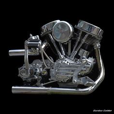 a chromed motorcycle engine is shown against a black background