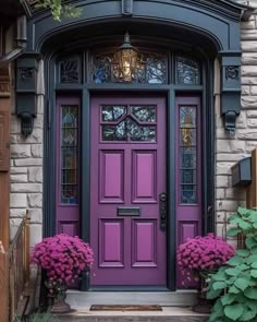 a purple front door with two pink hydrangeas