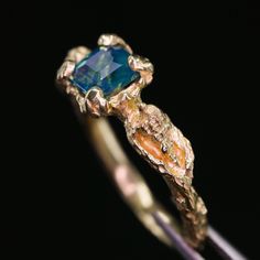 a gold ring with a blue stone in it