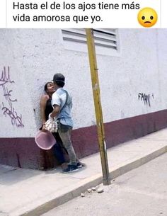 a man and woman kissing next to a wall with the caption that reads,