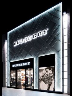 a burberry store front lit up at night