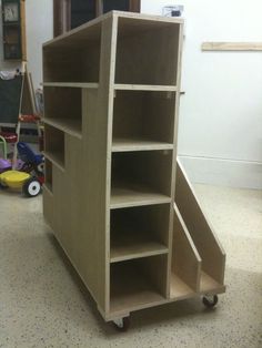 a wooden shelf sitting on top of a floor