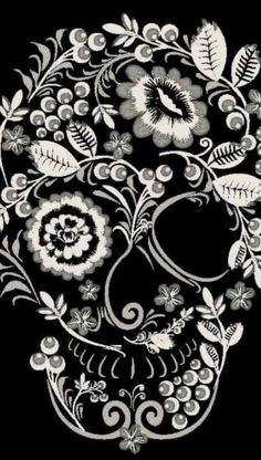 a black and white image of a skull with flowers