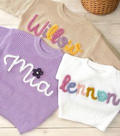 Our custom hand embroidered name sweaters are sure to look adorable on the sweet little one in your life!  Give them as gifts for baby showers, name announcements, first birthday's, Xmas gifts, and more!  Sweaters are a chunky knit and an oversized fit to wear as your baby grows.  These are perfect to wear in the fall, winter, or spring. Choose the color and size of your sweater in the above drop down.  Choose how many letters are in the name you want embroidered.  Fill in the personalization box with the name and thread color of your liking. Care Instructions Sweaters are made of 100% cotton.  Embroidery is made of 100% acrylic yarn.  We recommend to wash sweater inside out on delicate setting.  Do not wash with anything that has zippers, velcro, or heavy items to ensure your sweater last Cute White Sweater With Embroidered Text, White Cute Sweater With Embroidered Text, Customizable Cute Crew Neck Sweater, Cute Customizable Crew Neck Sweater, Cute Crew Neck Sweater With Custom Embroidery, Cute Cotton Sweater With Floral Embroidery, Cute White Embroidered Sweater, Cute Sweater With Letter Embroidery For Fall, Customizable Cute Winter Sweater