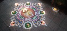 a decorated rangdi with lit candles on the ground