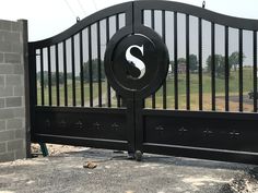 a black gate with the letter s on it