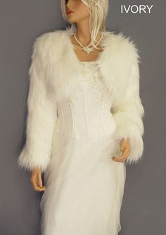 a mannequin wearing a white dress and fur coat