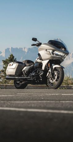 a white motorcycle parked on the side of a road