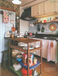 a kitchen filled with lots of clutter and cooking utensils