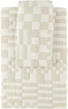 a white blanket with squares on it